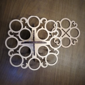 May include: A wooden, circular, decorative stand with 10 circular cutouts. The stand is designed to hold 10 glasses or cups.