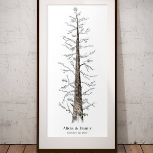 May include: A framed print of a hand-drawn tree with a brown trunk and green leaves. The tree is decorated with handwritten names and the text "Alicia & Danny October 12, 2017".
