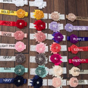 May include: A set of 16 flower headbands in various colors, including white, yellow, red, rose, light pink, gray, mint, navy, brown, lavender, purple, coral, magenta, cream, and blush. Each headband features a double flower with a lace trim.