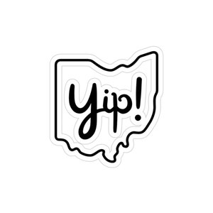 May include: A white sticker in the shape of Ohio with a black outline. The word "Yip!" is written in a black, cursive font inside the outline of the state.