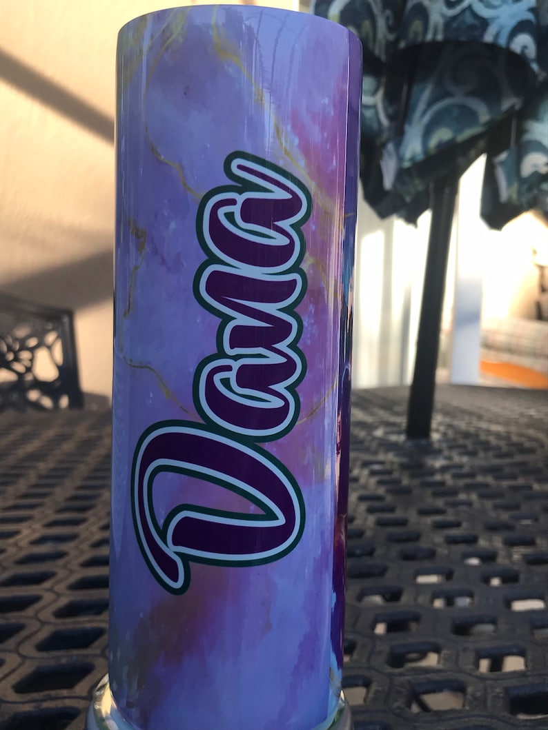 May include: A purple and gold marble-patterned tumbler with the name "Dana" written in a purple and green script.