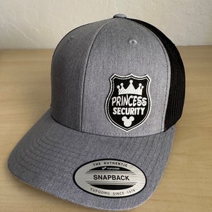 May include: Gray and black mesh trucker hat with a white embroidered patch that says "Princess Security" with a crown and a Mickey Mouse head.