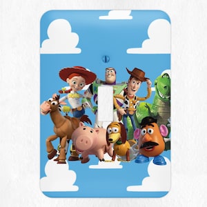 May include: A light switch cover featuring characters from the Toy Story movie franchise. The cover is blue with white clouds and features Woody, Buzz Lightyear, Jessie, Bullseye, Rex, Slinky Dog, and Mr. Potato Head.