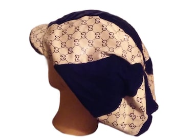 Baker boy hat. Black with tan and black Designer Fabric and gold center piece.