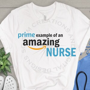 May include: White t-shirt with a blue and black graphic that says "prime example of an amazing NURSE".