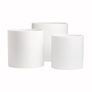 May include: Three white cylindrical ceramic planters of varying sizes. The planters are arranged in a staggered formation, with the largest planter in the back and the smallest planter in the front.