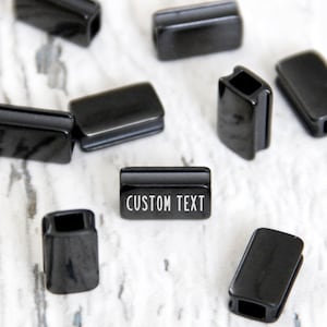 Custom spacers black beads. Engraved personalized gunmetal charm. Logo tag wholesale jewelry beads. Metal spacer rectangle label customized