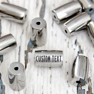 Custom bead bracelet spacers engraved. Persomalized tube silver metal name beads. Small memory charms wholesale. Logo gift word bead