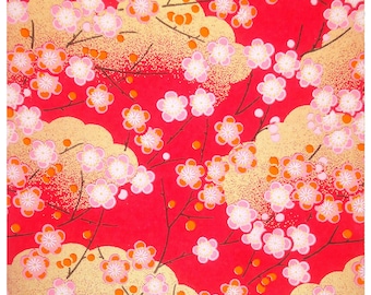 May include: Red background with a repeating pattern of pink and white flowers with gold accents. The flowers are arranged in a symmetrical pattern and are surrounded by gold clouds.
