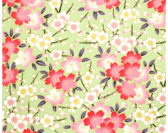 May include: A green background with a repeating pattern of pink and white flowers. The flowers are stylized and have a traditional Japanese design.