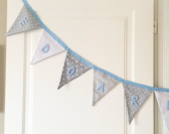 personalized fabric bunting banner in grey and white pattern with light blue felt name and to decorate your nursery