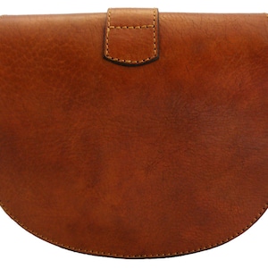 May include: A brown leather crossbody bag with a rounded bottom and a flap closure. The bag has a textured surface and visible stitching around the edges. The flap is secured with a small, rectangular buckle.