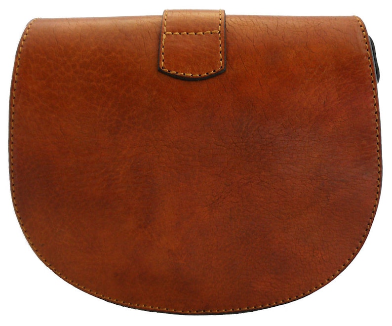May include: A brown leather crossbody bag with a rounded bottom and a flap closure. The bag has a textured surface and visible stitching around the edges. The flap is secured with a small, rectangular buckle.