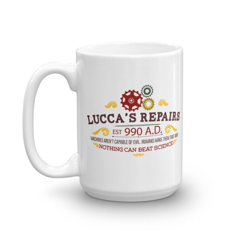 May include: White ceramic mug with the text "LUCCA'S REPAIRS EST 990 A.D." and the quote "MACHINES AREN'T CAPABLE OF EVIL. HUMANS MAKE THEM THAT WAY. NOTHING CAN BEAT SCIENCE." The design includes red, gold, and green gears.