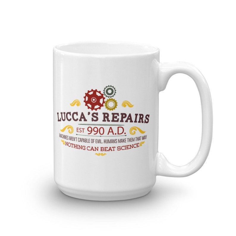 May include: White ceramic mug with the text "LUCCA'S REPAIRS EST 990 A.D." and the quote "MACHINES AREN'T CAPABLE OF EVIL. HUMANS MAKE THEM THAT WAY. NOTHING CAN BEAT SCIENCE." The mug features a handle and a design with gears.