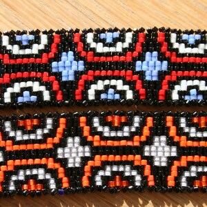 May include: Two beaded bracelets with black, white, red, orange, and blue beads in a geometric pattern.