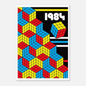May include: A poster with a geometric design of Rubik's Cubes in red, yellow, and blue. The word "1984" is displayed in white, bold font against a black background, with yellow, white, and blue horizontal stripes.