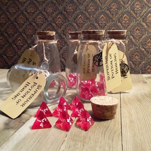 May include: Six small glass bottles with cork tops, each containing a red four-sided die. The bottles are labelled with brown paper tags that read "Superior Potion of Healing".