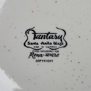 May include: Black and white logo on a white background that reads "Fantasy Santa Anita Ware Made in California Styled Exclusively for Rena-ware Copyright"