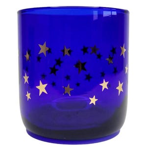 May include: A cobalt blue glass candle holder with a gold star pattern.