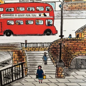 May include: A red double-decker bus with the text "GUINNESS IS GOOD FOR YOU" on the side. The bus is driving on a street with a brick building and a bridge in the background.