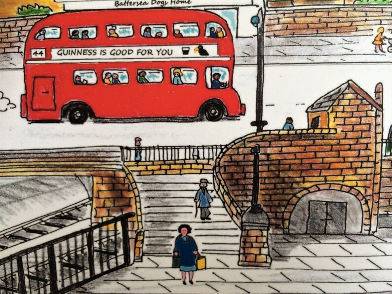 May include: A red double-decker bus with the text "GUINNESS IS GOOD FOR YOU" on the side. The bus is driving on a street with a brick building and a bridge in the background.