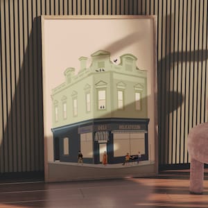 May include: A framed art print depicting a two-story building with a deli on the ground floor. The building is light green with dark blue accents and the words "DELI DELICATESSEN" are visible. Several people are depicted outside the deli.