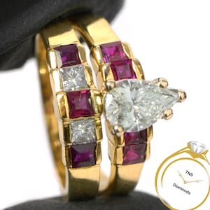 May include: A pear-shaped diamond engagement ring set with a band of alternating ruby and diamond stones. The ring is set in yellow gold.