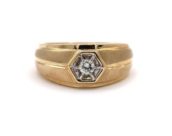 May include: A gold band ring with a single diamond set in a hexagonal design.