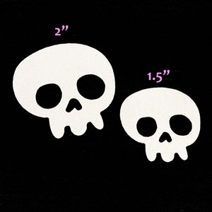 May include: Two white skull stickers, one measuring 2 inches and the other 1.5 inches.