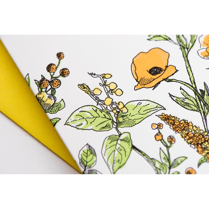 May include: A white background with a floral pattern in shades of yellow and green. The pattern includes a large orange poppy flower, small yellow flowers, and green leaves.