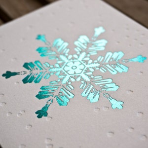 Carte de voeux typographique bleue en flocon de neige