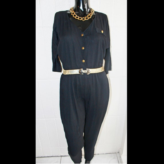 black jumpsuit with gold buttons