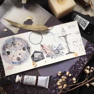 May include: A watercolor painting of a clock face with Roman numerals, a magnifying glass, a hand holding a quill pen, a candlestick, and a book. The painting is on a white background with a few dried leaves and a white candle.