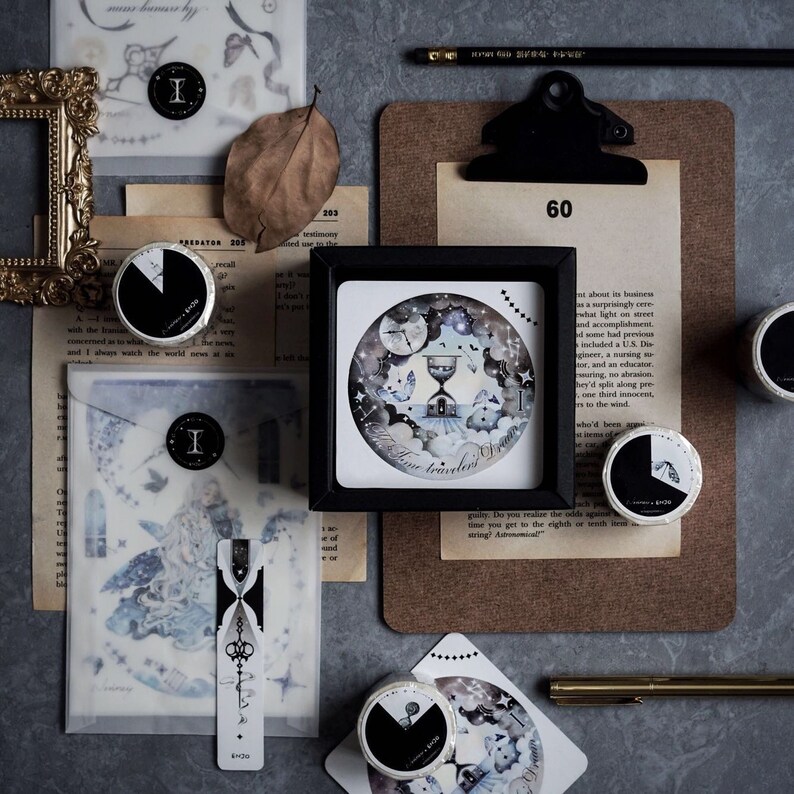 May include: A black and white illustration of a house with a clock tower, a butterfly, and an hourglass. The illustration is surrounded by stars and the text "Time Traveler's Dream".