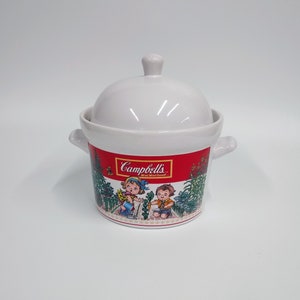 May include: White ceramic soup tureen with a red and white lid. The tureen features a colorful illustration of two children in a garden with the text "Campbell's M'm! M'm! Good!"