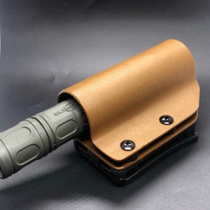 Flashlight holder muzzle down.