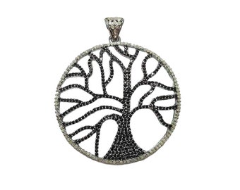 May include: A silver pendant in the shape of a tree of life, with black and white cubic zirconia stones.