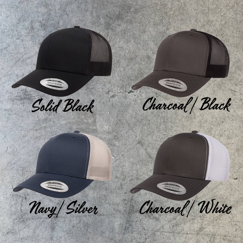 May include: Four trucker hats in different color combinations. The hats are black, charcoal with black mesh, navy with silver mesh, and charcoal with white mesh. Each hat has a Snapback closure and a label that says "SNAPBACK".