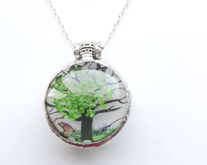 Very pretty, real pressed flower pendant. Brught green leaves on a tree with butterfly scene.