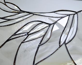 Modern almost colourless stained glass window panel with shiny glass bevels.