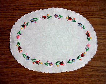 Hand-embroidered oval doily. Handmade Hungarian embroidery ("Kalocsa" motives)