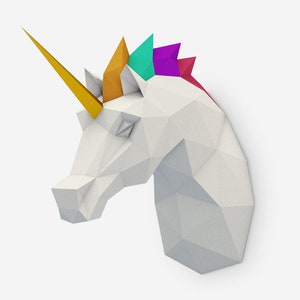 May include: A white origami unicorn head with a gold horn and a colorful mane. The mane is made of paper and is folded into a series of triangles. The colors of the mane are teal, purple, and red.