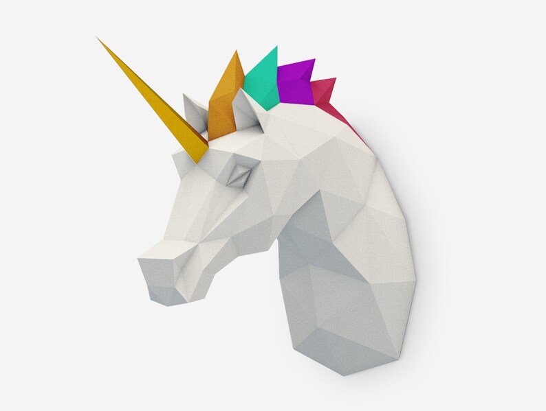 May include: A white origami unicorn head with a gold horn and a colorful mane. The mane is made of paper and is folded into a series of triangles. The colors of the mane are teal, purple, and red.