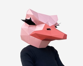 May include: A pink and red papercraft mask of an ostrich with black eyelashes. The mask is designed to be worn over the head.