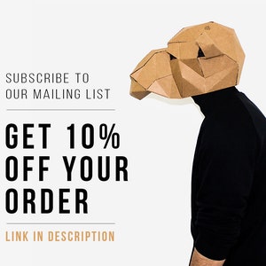 May include: A person wearing a brown cardboard camel mask, standing in front of a white background. The text on the image reads: "Subscribe to our mailing list. Get 10% off your order. Link in description."