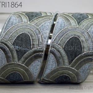 two decorative fabric pieces with a repeating pattern of curved lines and circles in shades of gray and black. The text "GTRI1864" is visible, which may indicate the brand or product name.
