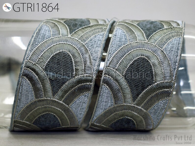 two decorative fabric pieces with a repeating pattern of curved lines and circles in shades of gray and black. The text "GTRI1864" is visible, which may indicate the brand or product name.