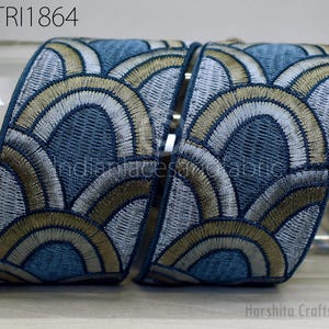 a decorative fabric with a repeating pattern of blue and gold circles, creating a visually appealing and intricate design.