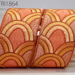 a decorative fabric with a repeating pattern of orange and yellow circles, creating a visually appealing design.